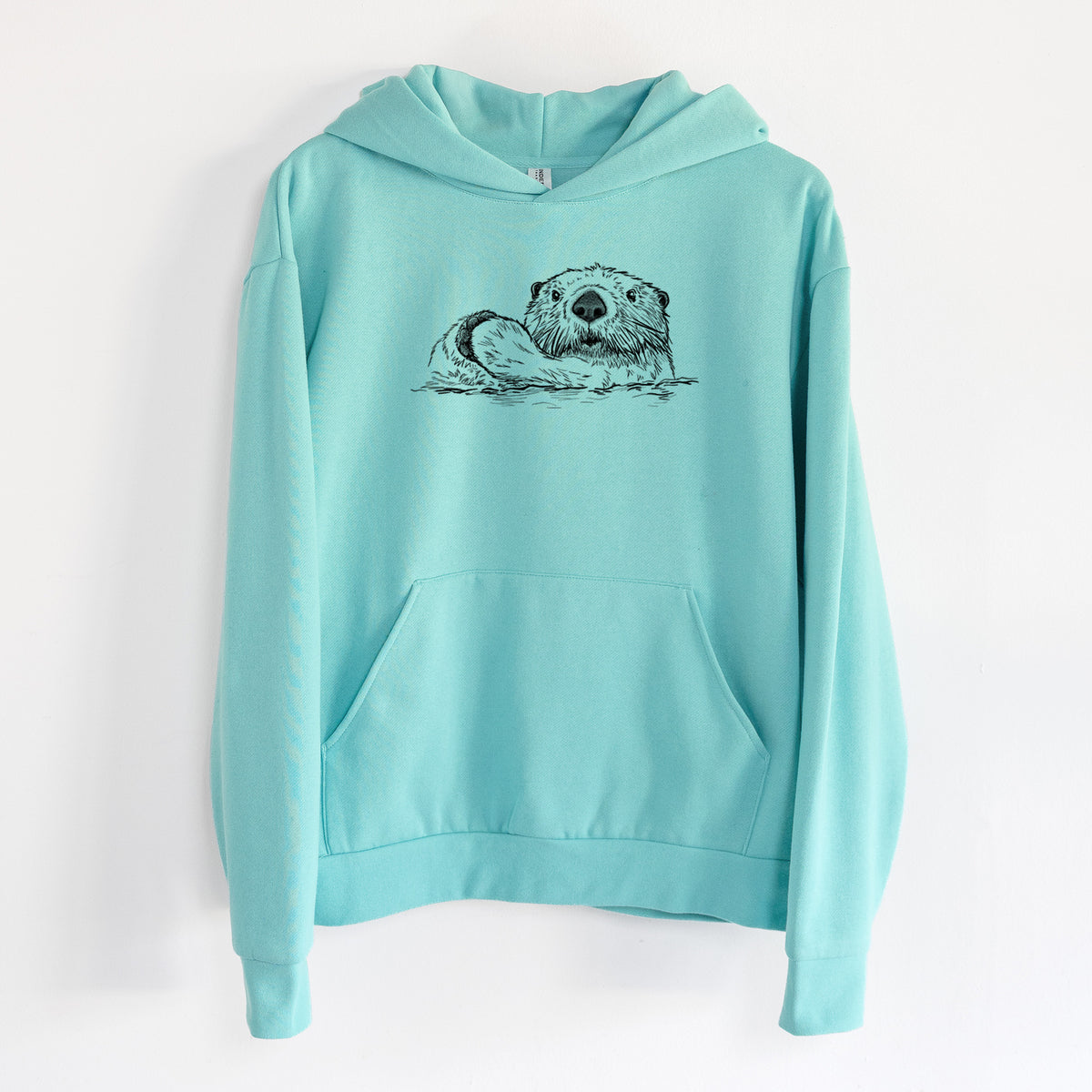 Northern Sea Otter - Enhydra lutris kenyoni - Statement Midweight Hoodie in Seafoam, hanging on a white wall, with a front kangaroo pocket and no drawcords.