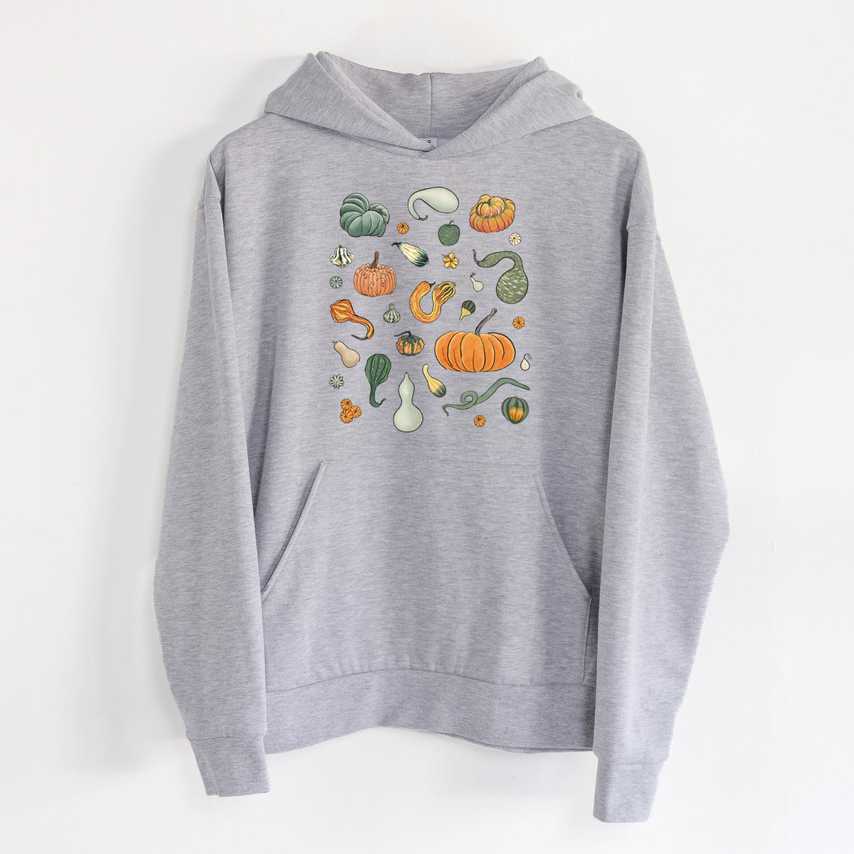 Pumpkin Patch Finds - Statement Midweight Hoodie in Heather Grey, hanging on a white wall, with a front kangaroo pocket and no drawcords.