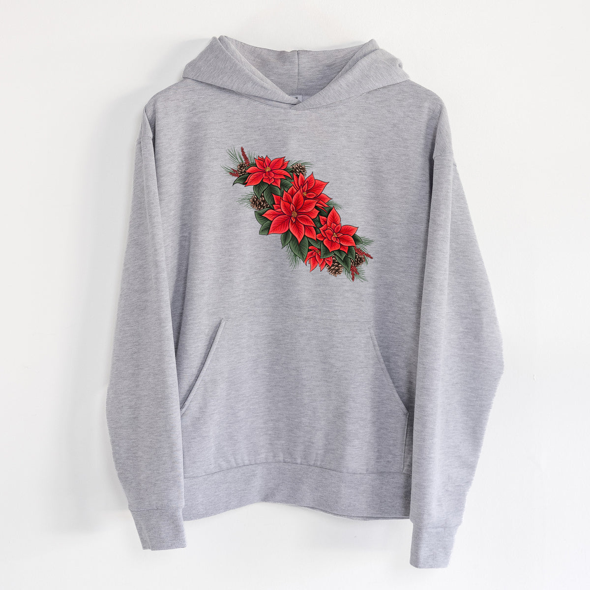 Winter Poinsettias - Euphorbia pulcherrima - Statement Midweight Hoodie in Heather Grey, hanging on a white wall, with a front kangaroo pocket and no drawcords.