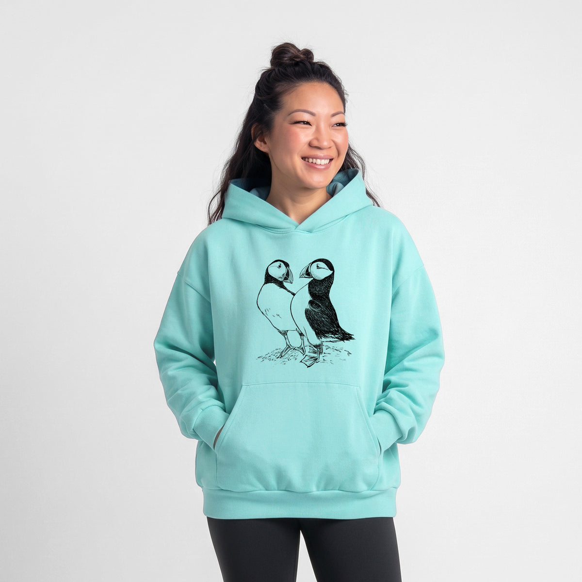 Female model wearing the Atlantic Puffins Pair - Fratercula arctica - Statement Midweight Hoodie.