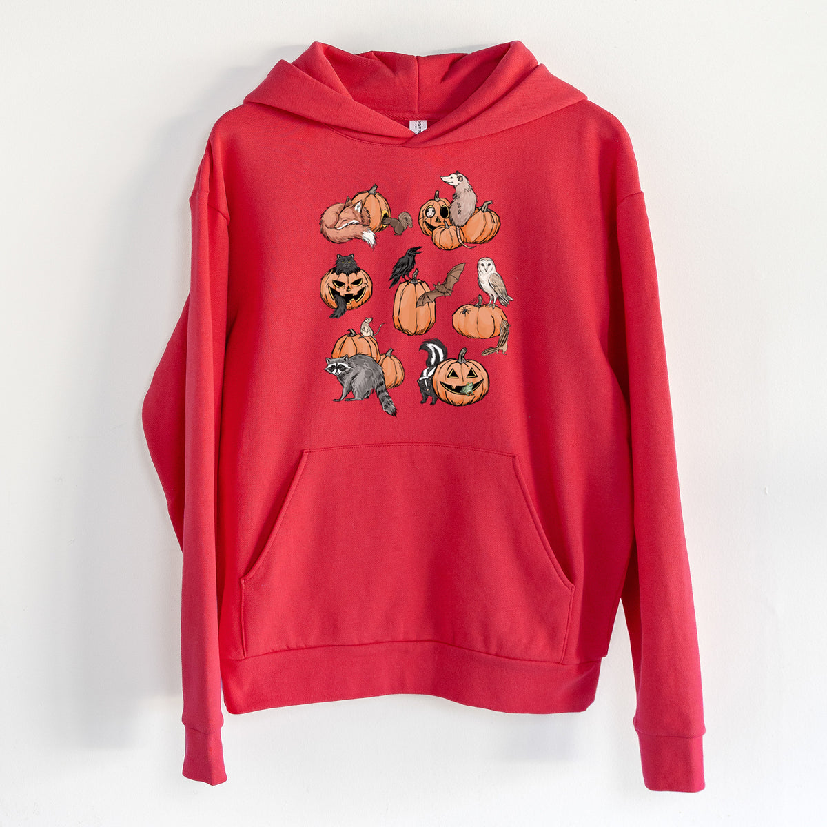 Woodland Pumpkin Patch Party - Statement Midweight Hoodie in Cherry Red, hanging on a white wall, with a front kangaroo pocket and no drawcords.