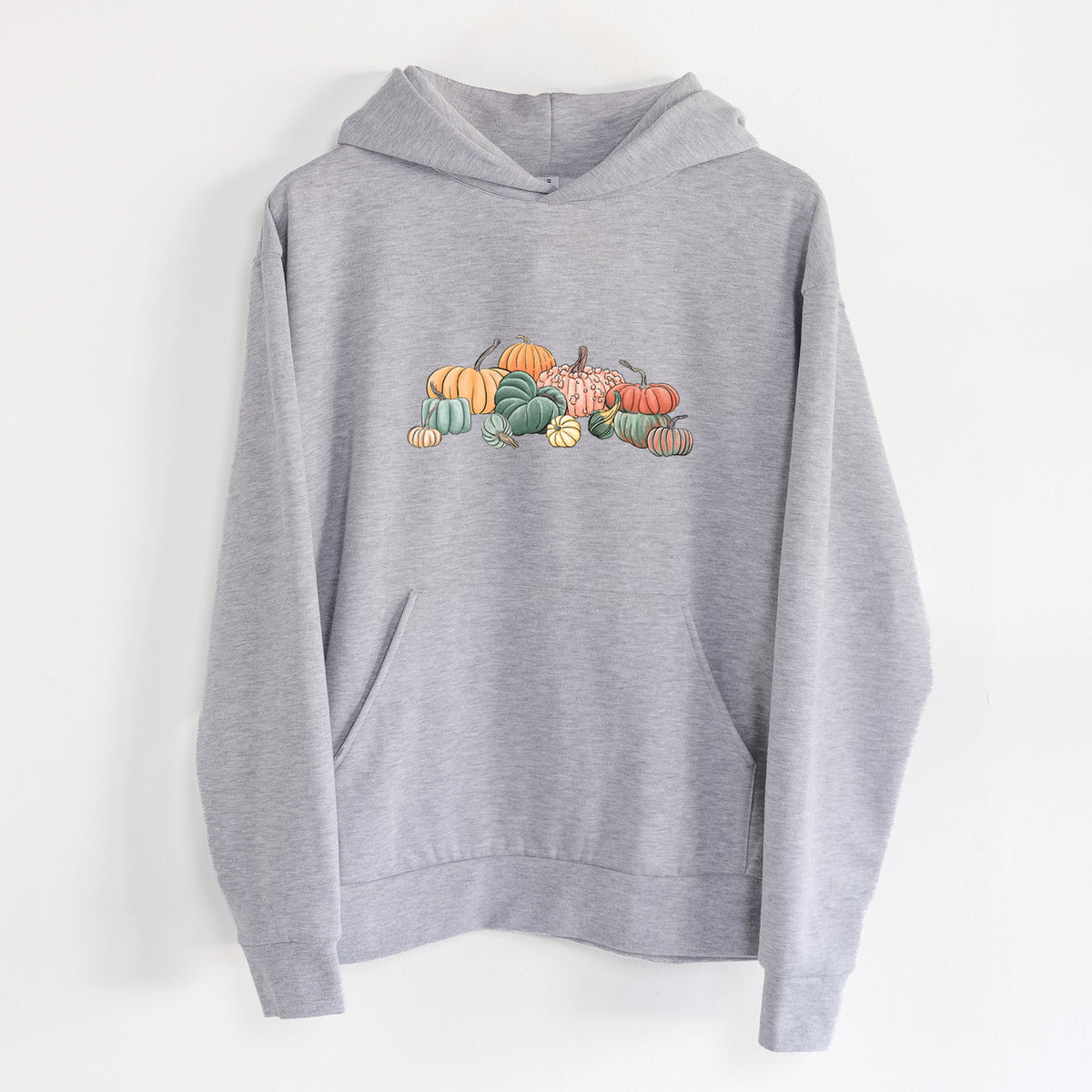 Pumpkin Harvest - Statement Midweight Hoodie in Heather Grey, hanging on a white wall, with a front kangaroo pocket and no drawcords.