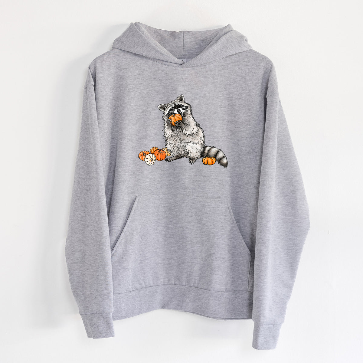 Raccoon Pumpkin Bandit - Statement Midweight Hoodie in Heather Grey, hanging on a white wall, with a front kangaroo pocket and no drawcords.