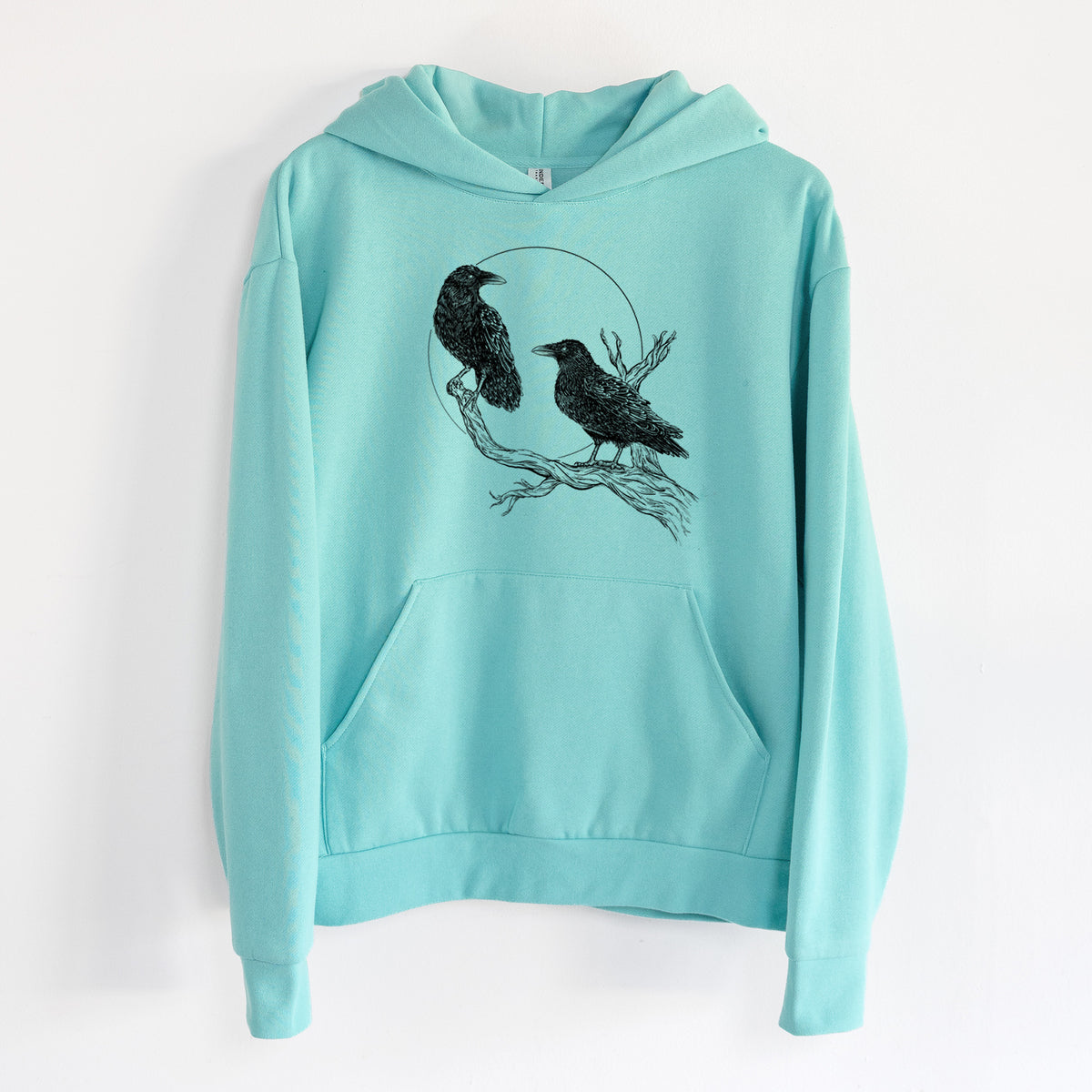 Midnight Ravens - Statement Midweight Hoodie in Seafoam, hanging on a white wall, with a front kangaroo pocket and no drawcords.