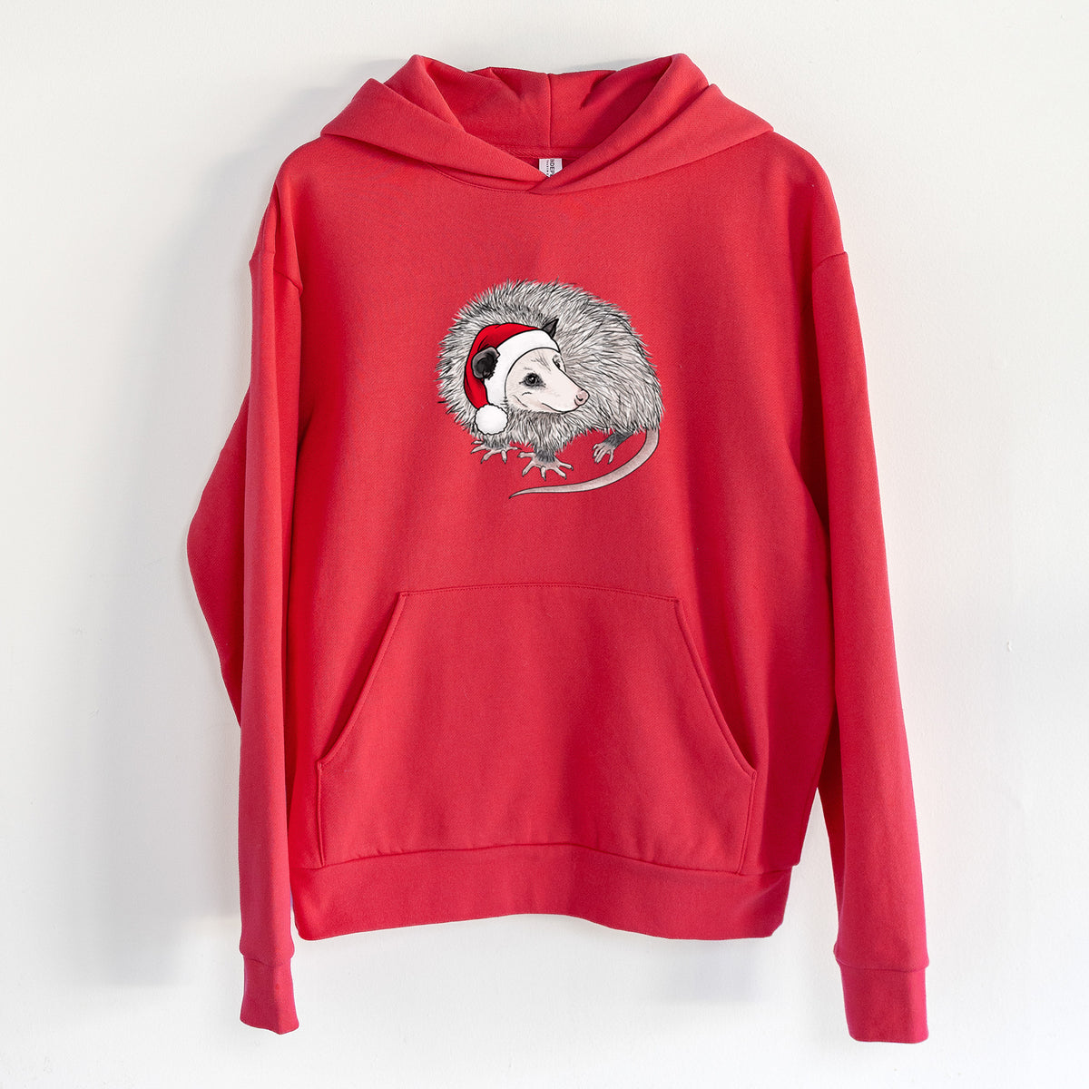 Santa Opossum - Statement Midweight Hoodie in Cherry Red, hanging on a white wall, with a front kangaroo pocket and no drawcords.