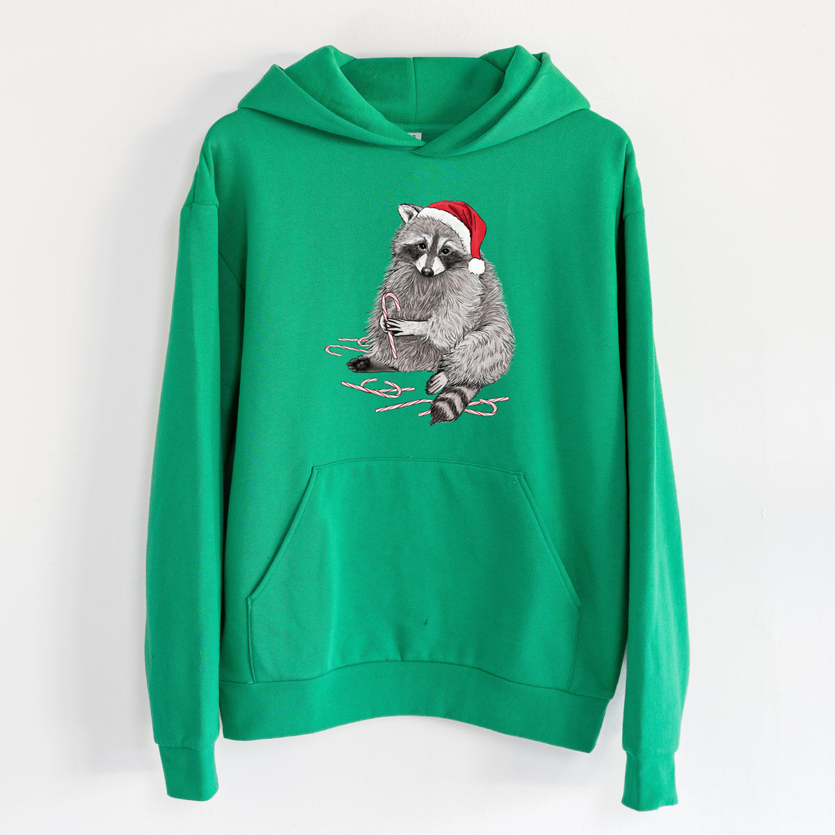 Santa Raccoon - Statement Midweight Hoodie in Kelly Green, hanging on a white wall, with a front kangaroo pocket and no drawcords.