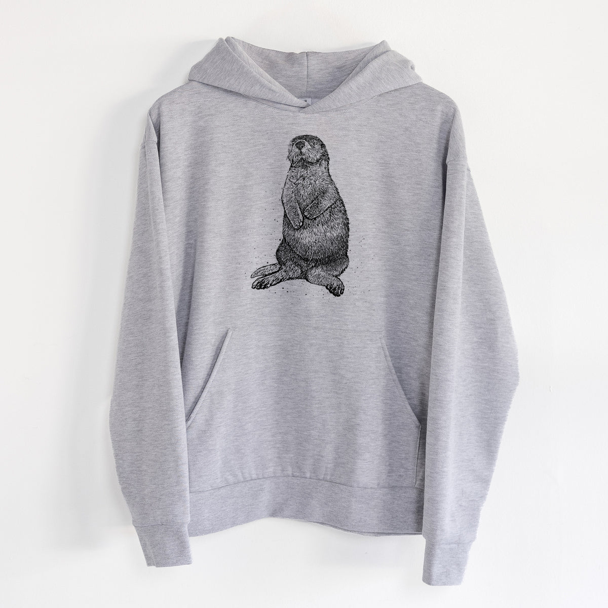 Enhydra lutris - California Sea Otter - Statement Midweight Hoodie in Heather Grey, hanging on a white wall, with a front kangaroo pocket and no drawcords.
