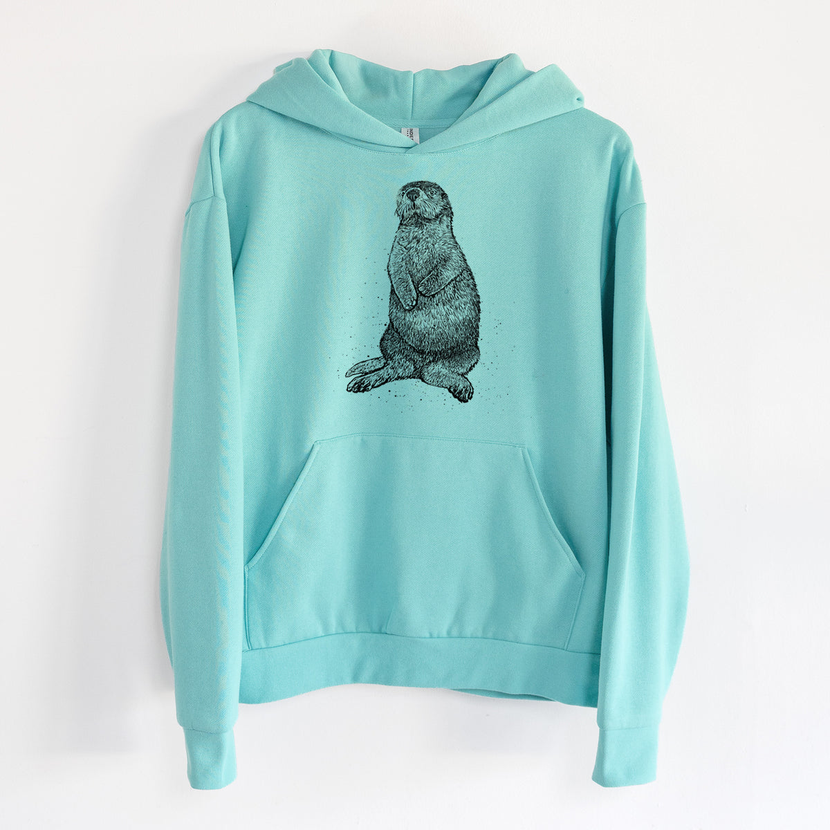 Enhydra lutris - California Sea Otter - Statement Midweight Hoodie in Seafoam, hanging on a white wall, with a front kangaroo pocket and no drawcords.