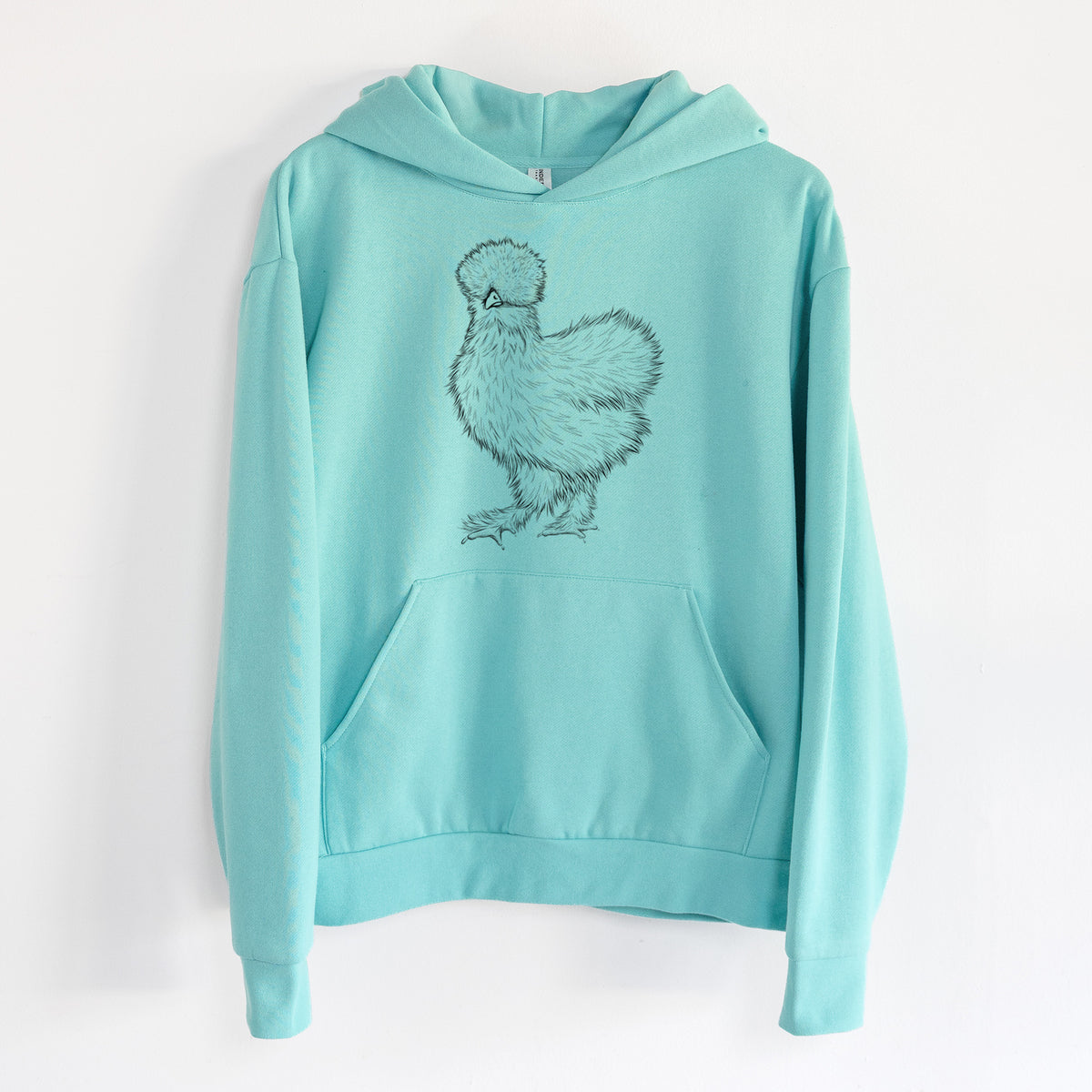 Silkie Chicken - Statement Midweight Hoodie in Seafoam, hanging on a white wall, with a front kangaroo pocket and no drawcords.