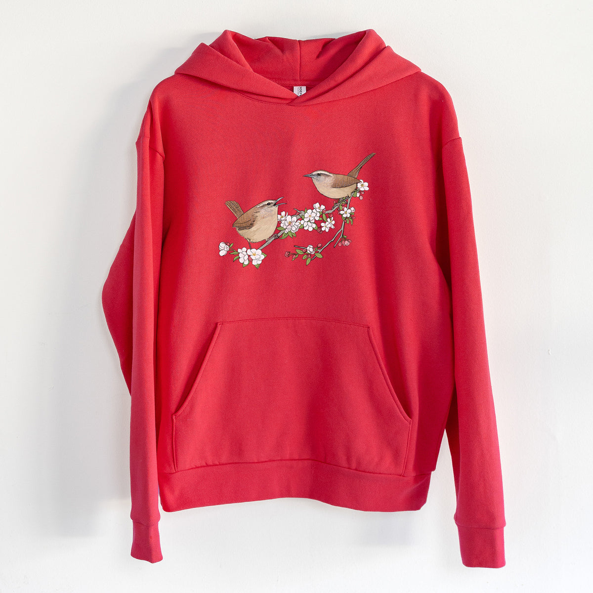 Spring Carolina Wrens on a Blooming Crabtree Branch - Statement Midweight Hoodie in Cherry Red, hanging on a white wall, with a front kangaroo pocket and no drawcords.