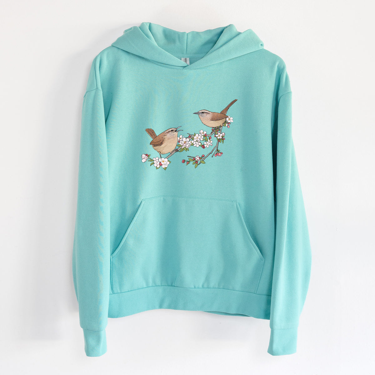 Spring Carolina Wrens on a Blooming Crabtree Branch - Statement Midweight Hoodie in Seafoam, hanging on a white wall, with a front kangaroo pocket and no drawcords.