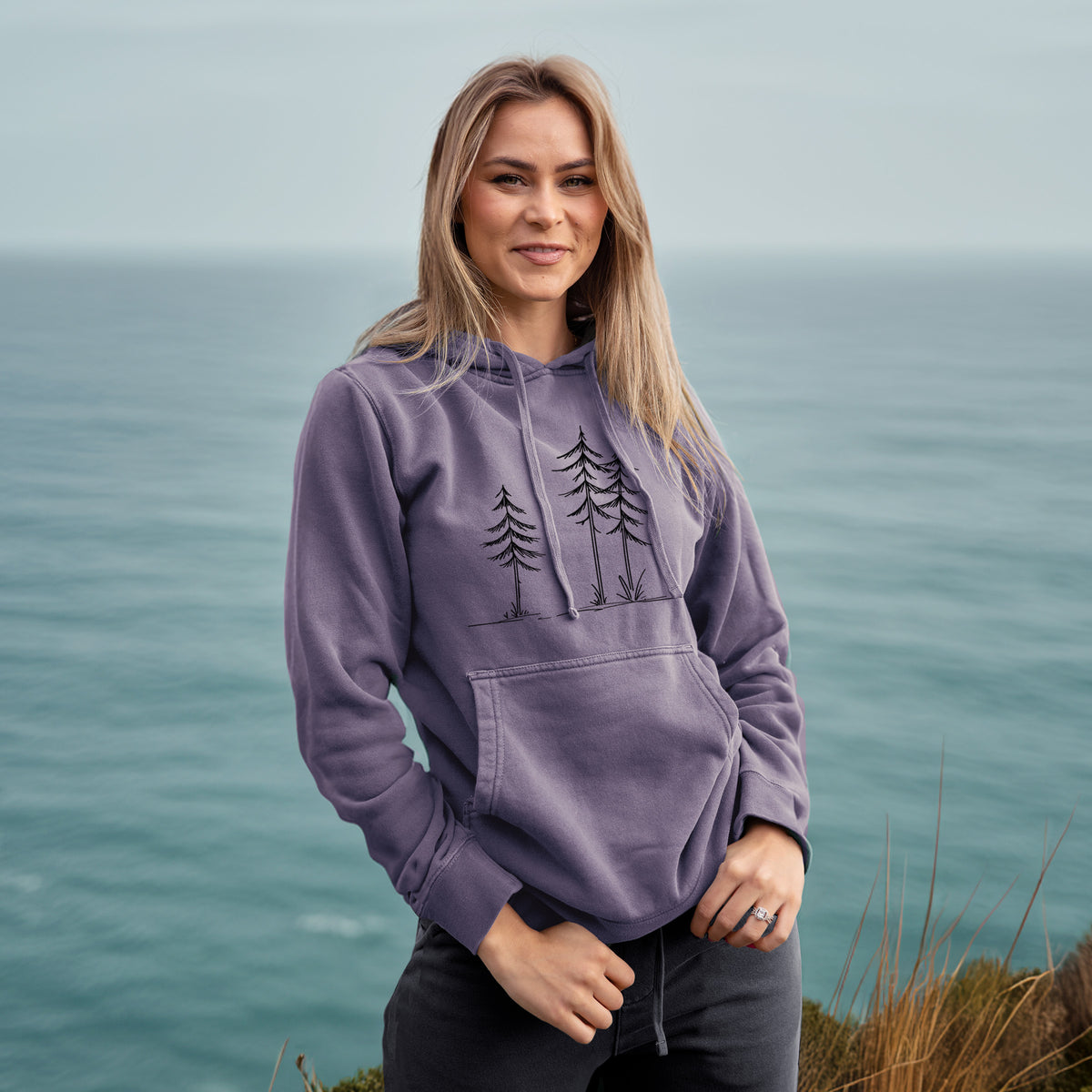 Three Pines - Unisex Pigment Dyed Hoodie in Plum, worn by model