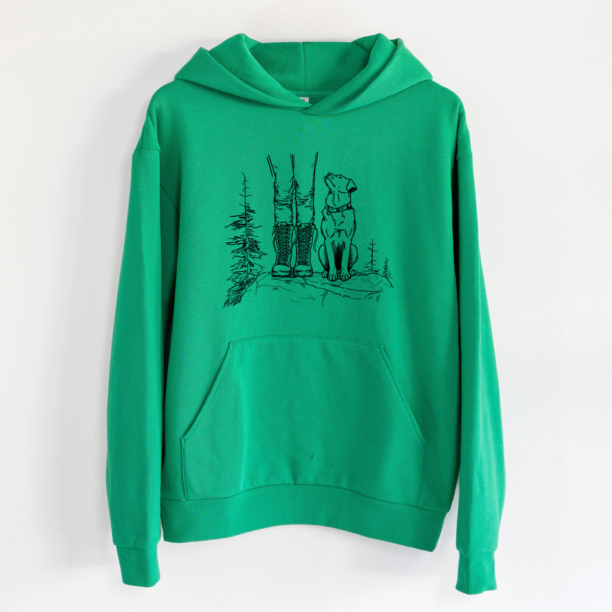 Trail Companions - Hiking with Dogs - Statement Midweight Hoodie in Kelly Green, hanging on a white wall, with a front kangaroo pocket and no drawcords.