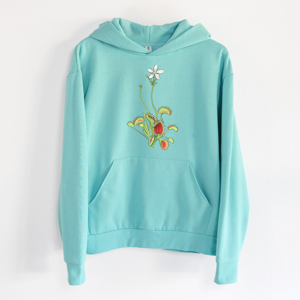 Colorful Carnivorous Venus Fly Trap - Statement Midweight Hoodie in Seafoam, hanging on a white wall, with a front kangaroo pocket and no drawcords.