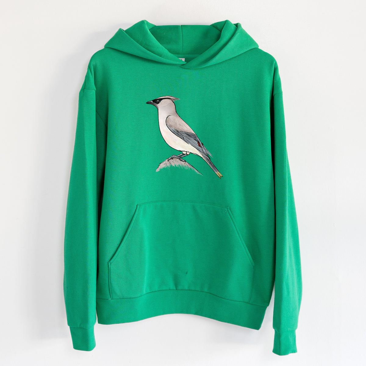 Vibrant Cedar Waxwing - Bombycilla cedrorum - Statement Midweight Hoodie in Kelly Green, hanging on a white wall, with a front kangaroo pocket and no drawcords.