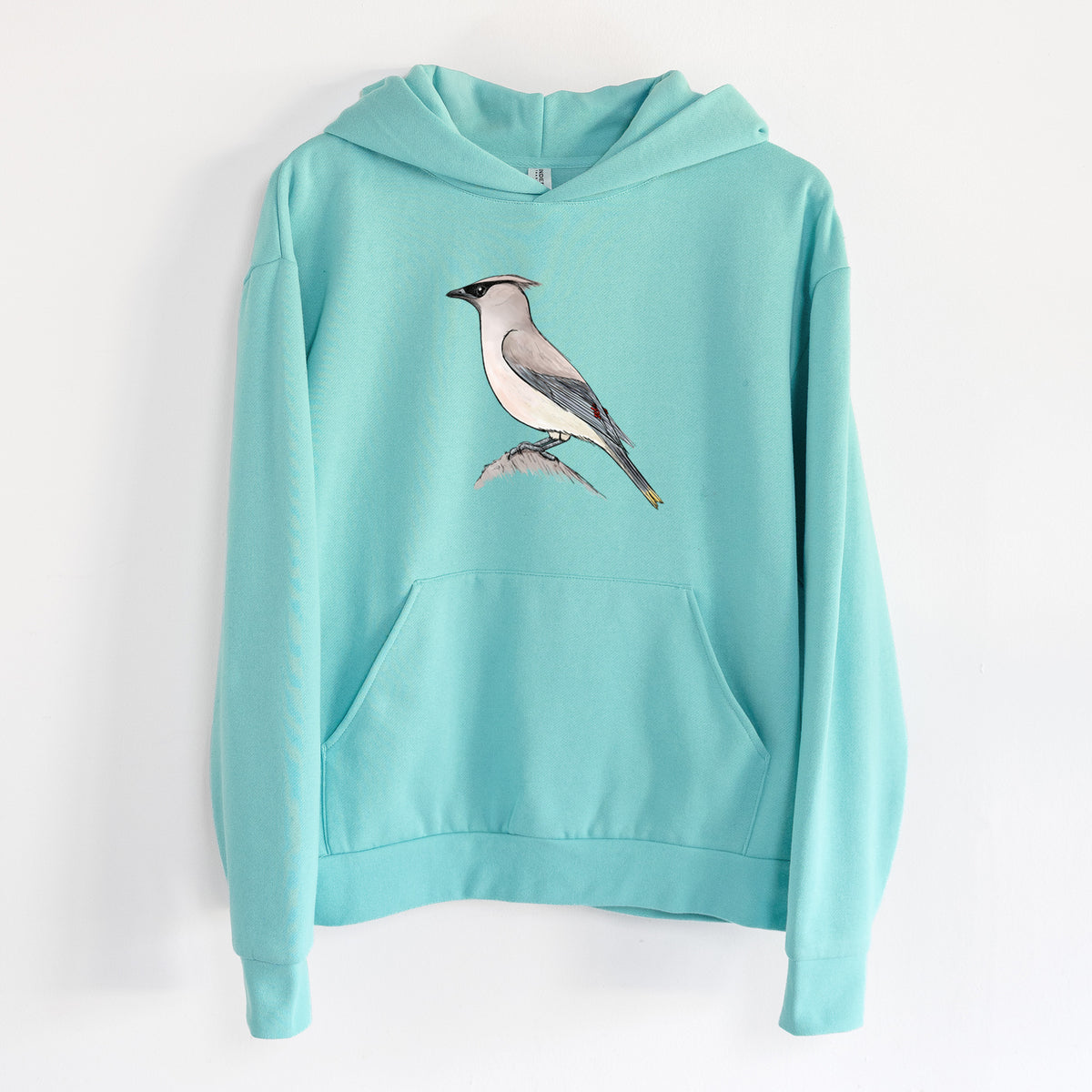Vibrant Cedar Waxwing - Bombycilla cedrorum - Statement Midweight Hoodie in Seafoam, hanging on a white wall, with a front kangaroo pocket and no drawcords.