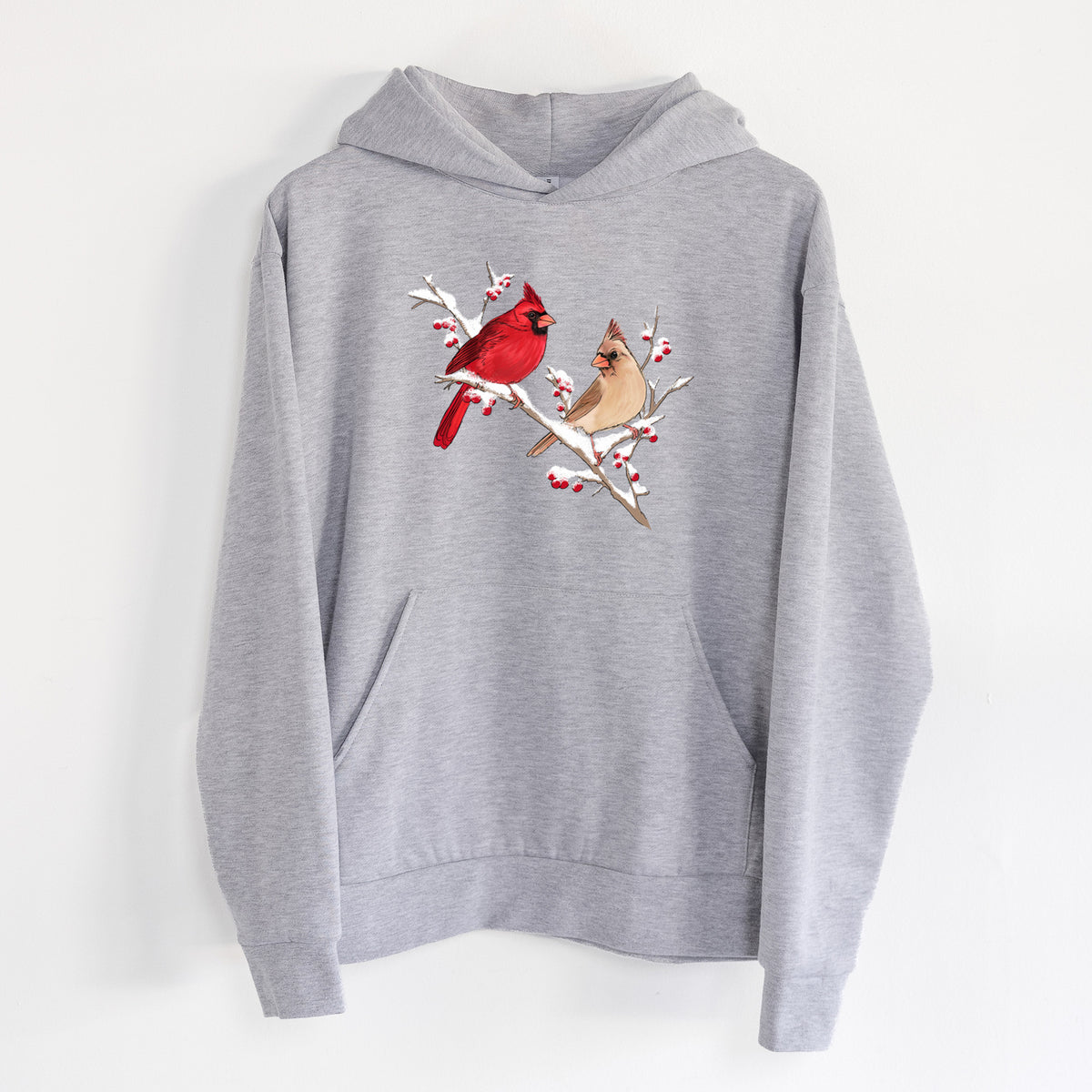 Winter Cardinals - Statement Midweight Hoodie in Heather Grey, hanging on a white wall, with a front kangaroo pocket and no drawcords.