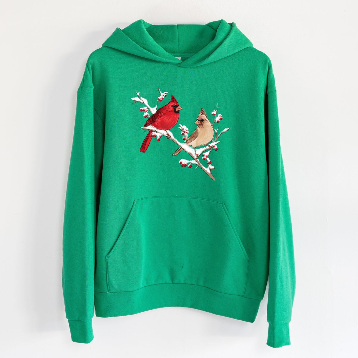 Winter Cardinals - Statement Midweight Hoodie in Kelly Green, hanging on a white wall, with a front kangaroo pocket and no drawcords.