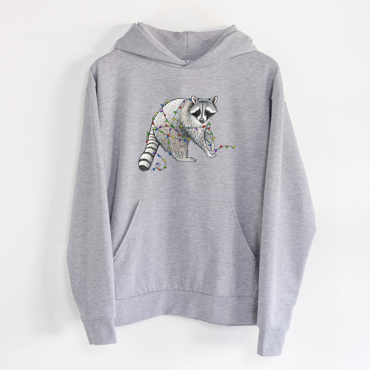 Christmas Raccoon - Statement Midweight Hoodie in Heather Grey, hanging on a white wall, with a front kangaroo pocket and no drawcords.